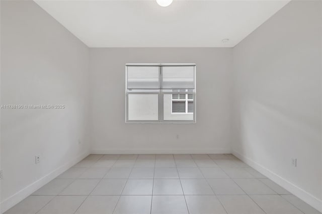 spare room with baseboards