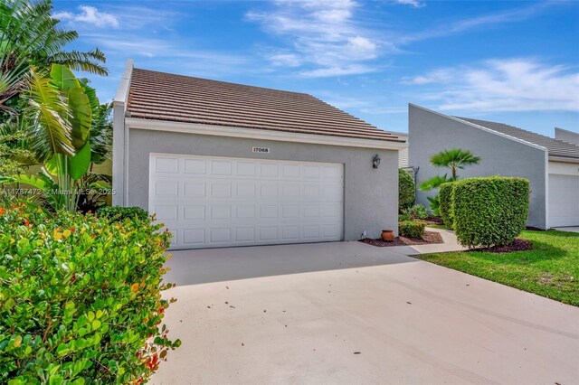 17068 Traverse Cir, Jupiter, FL 33477 - garage with concrete driveway