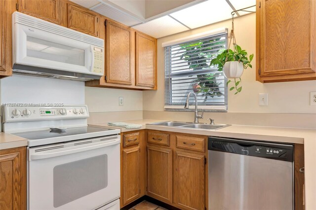 17068 Traverse Cir, Jupiter, FL 33477 - kitchen featuring white appliances, a sink, light countertops, and brown cabinetry