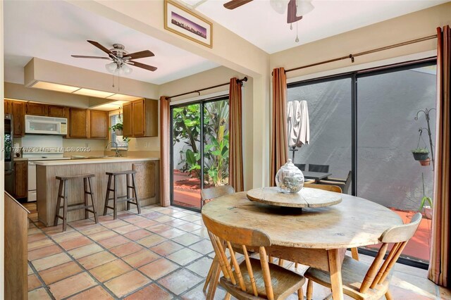 17068 Traverse Cir, Jupiter, FL 33477 - dining area with a ceiling fan and light tile patterned flooring