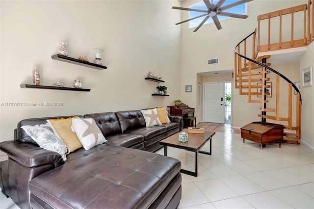 17068 Traverse Cir, Jupiter, FL 33477 - living room with a ceiling fan, stairway, light tile patterned floors, a high ceiling, and baseboards