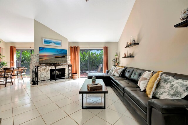 17068 Traverse Cir, Jupiter, FL 33477 - tiled living room featuring a stone fireplace and high vaulted ceiling
