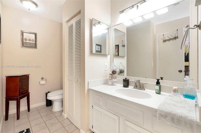 17068 Traverse Cir, Jupiter, FL 33477 - bathroom featuring a closet, vanity, toilet, tile patterned flooring, and baseboards