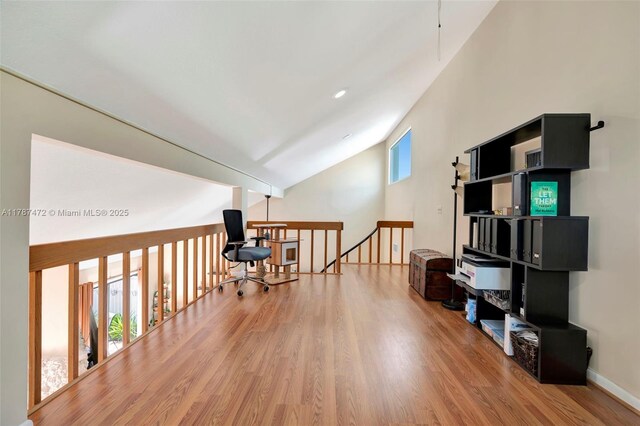 17068 Traverse Cir, Jupiter, FL 33477 - living area featuring wood finished floors, an upstairs landing, vaulted ceiling, and baseboards