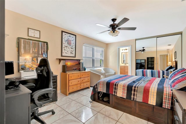 17068 Traverse Cir, Jupiter, FL 33477 - bedroom featuring an office area, connected bathroom, ceiling fan, and light tile patterned flooring