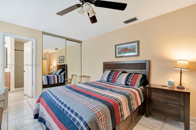 17068 Traverse Cir, Jupiter, FL 33477 - bedroom featuring a closet, light tile patterned floors, a ceiling fan, and ensuite bath