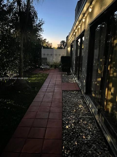 17068 Traverse Cir, Jupiter, FL 33477 - yard at dusk with a patio area