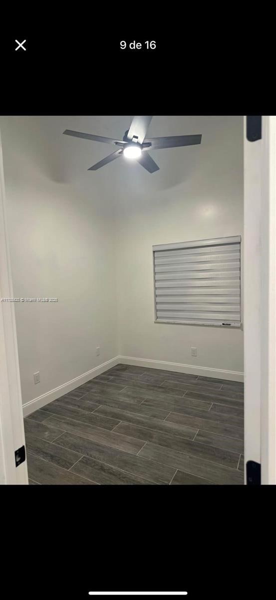 spare room featuring baseboards, ceiling fan, and wood finish floors