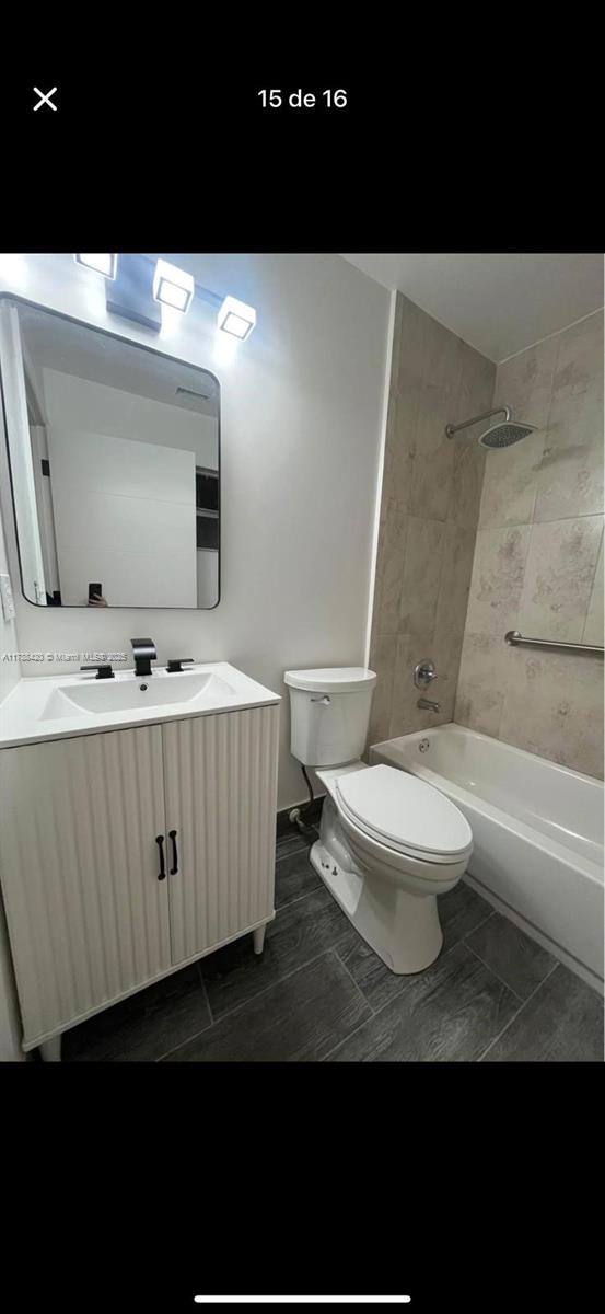 full bathroom featuring shower / tub combination, vanity, and toilet