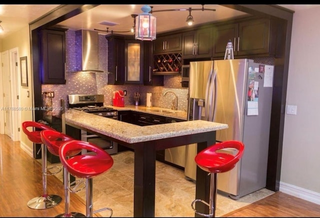 6472 Johnson St, Hollywood, FL 33024 - kitchen with backsplash, wall chimney range hood, a sink, light stone countertops, and appliances with stainless steel finishes