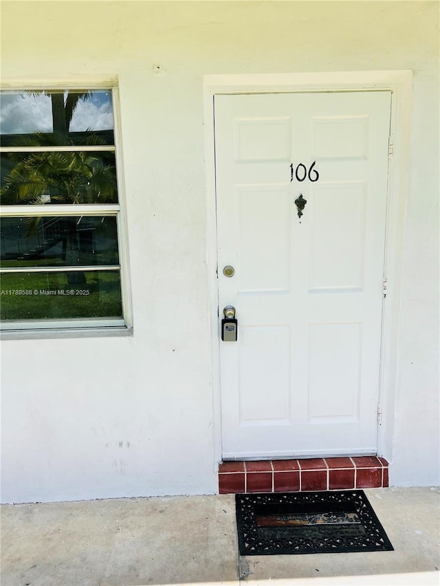 6191 SW 37th St Unit 106, Davie, FL 33314 - view of exterior entry featuring stucco siding
