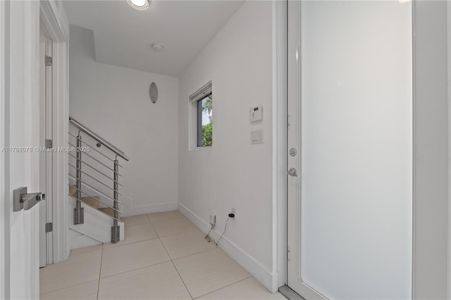 hall with tile patterned floors and baseboards