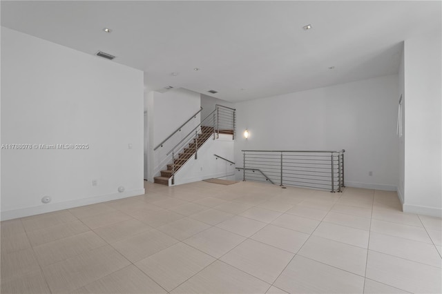 spare room featuring visible vents, baseboards, and light tile patterned floors