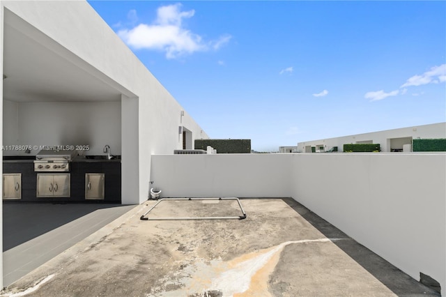 view of patio / terrace featuring a sink, area for grilling, and a grill