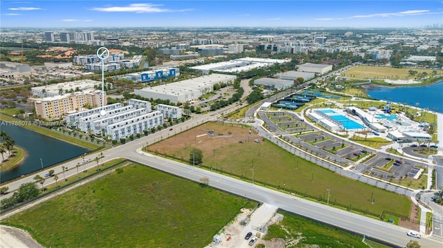 drone / aerial view with a city view and a water view