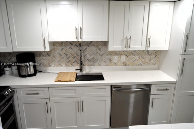 kitchen with backsplash, white cabinetry, stainless steel dishwasher, and a sink