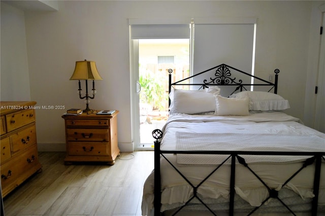 bedroom with baseboards and light wood finished floors