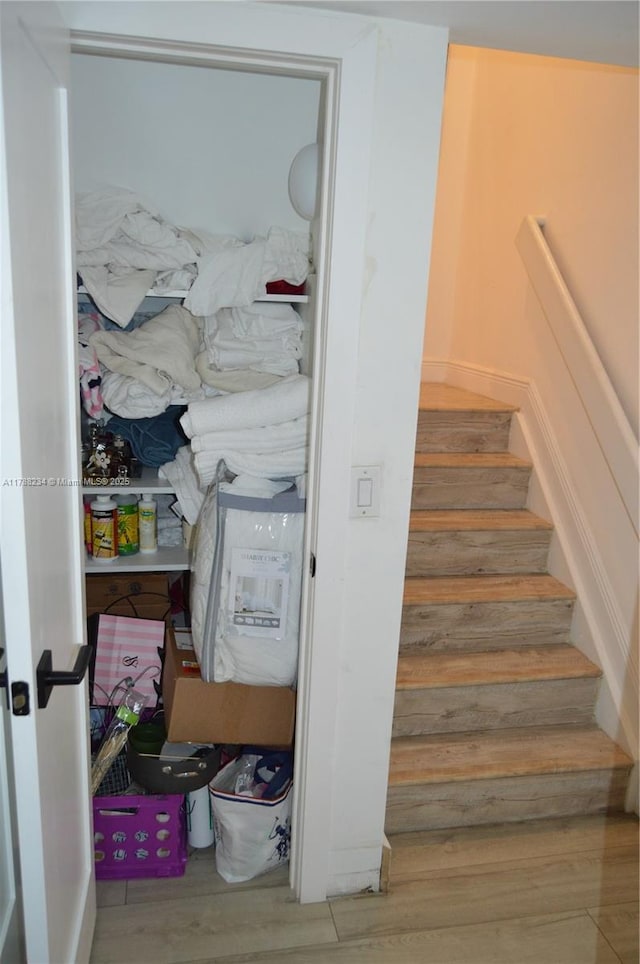 staircase with wood finished floors