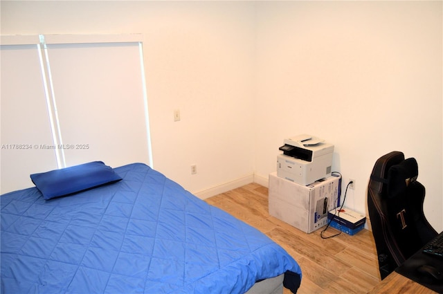 bedroom featuring light wood-style flooring