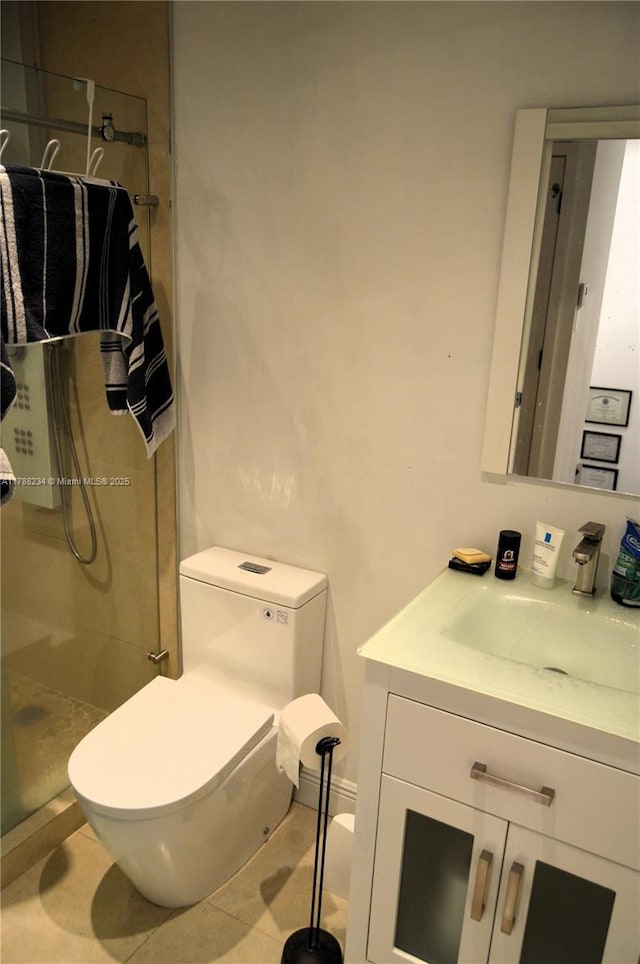 full bathroom featuring toilet, a stall shower, and vanity