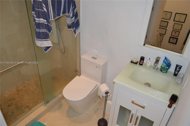 bathroom with a shower stall, toilet, tile patterned flooring, and vanity
