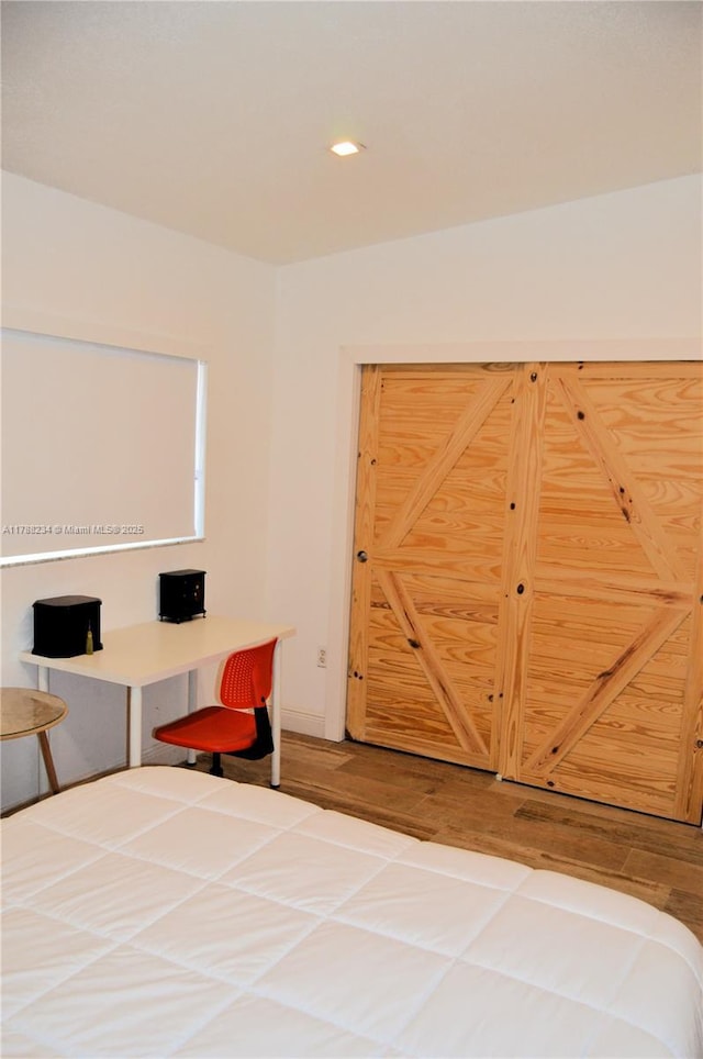 bedroom featuring wood finished floors and recessed lighting