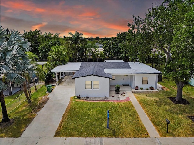 1550 NE 11th St, Homestead, FL 33033 - view of front of home with driveway, stucco siding, and a carport