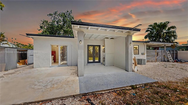 1550 NE 11th St, Homestead, FL 33033 - rear view of property featuring french doors, a patio, stucco siding, a gate, and cooling unit