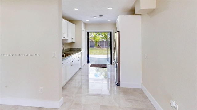 1550 NE 11th St, Homestead, FL 33033 - hallway with baseboards, light marble finish floors, recessed lighting, and a sink