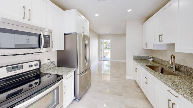 1550 NE 11th St, Homestead, FL 33033 - kitchen with appliances with stainless steel finishes, a sink, light stone counters, white cabinetry, and recessed lighting