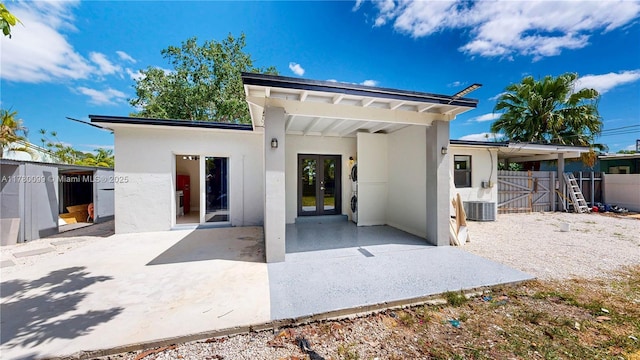 1550 NE 11th St, Homestead, FL 33033 - back of property with french doors, a patio, stucco siding, and cooling unit