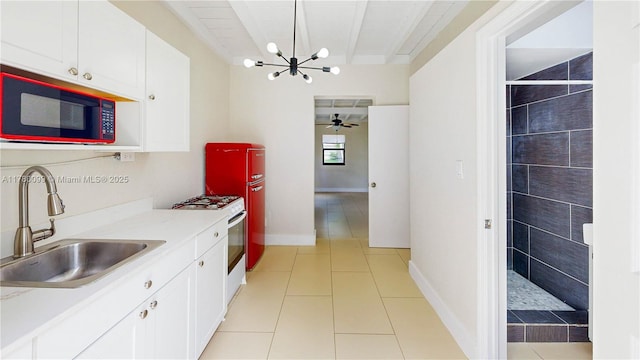 1550 NE 11th St, Homestead, FL 33033 - kitchen featuring a sink, a chandelier, white range with gas stovetop, and white cabinetry