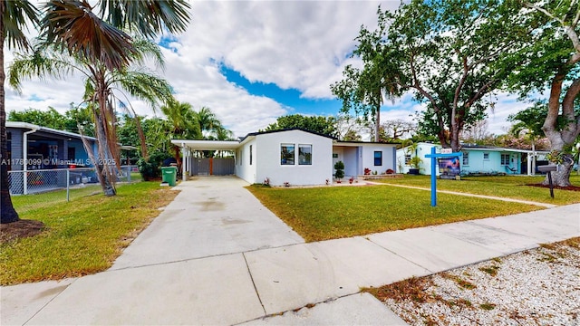 1550 NE 11th St, Homestead, FL 33033 - view of front facade with concrete driveway, an attached carport, and stucco siding