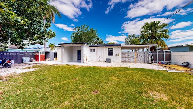 1550 NE 11th St, Homestead, FL 33033 - back of house featuring a gate, stucco siding, central AC, and a patio
