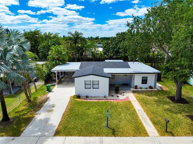 1550 NE 11th St, Homestead, FL 33033 - view of front of property with concrete driveway, a carport, and stucco siding