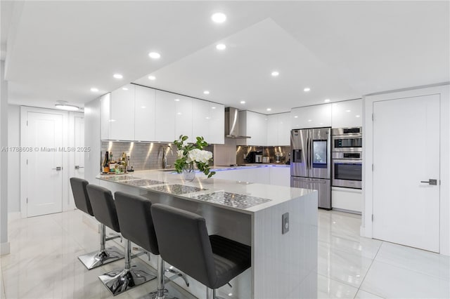 2500 Parkview Dr Unit 1121, Hallandale Beach, FL 33009 - kitchen with wall chimney exhaust hood, modern cabinets, white cabinetry, and appliances with stainless steel finishes
