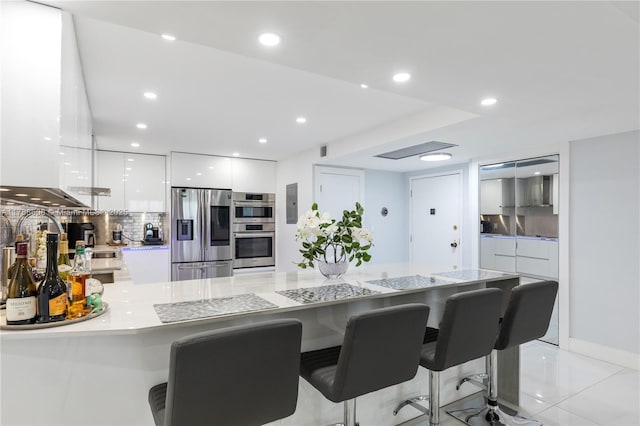 2500 Parkview Dr Unit 1121, Hallandale Beach, FL 33009 - kitchen with white cabinets, stainless steel appliances, light countertops, modern cabinets, and tasteful backsplash