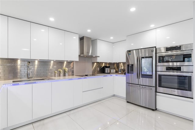 2500 Parkview Dr Unit 1121, Hallandale Beach, FL 33009 - kitchen with wall chimney exhaust hood, white cabinetry, modern cabinets, light countertops, and appliances with stainless steel finishes