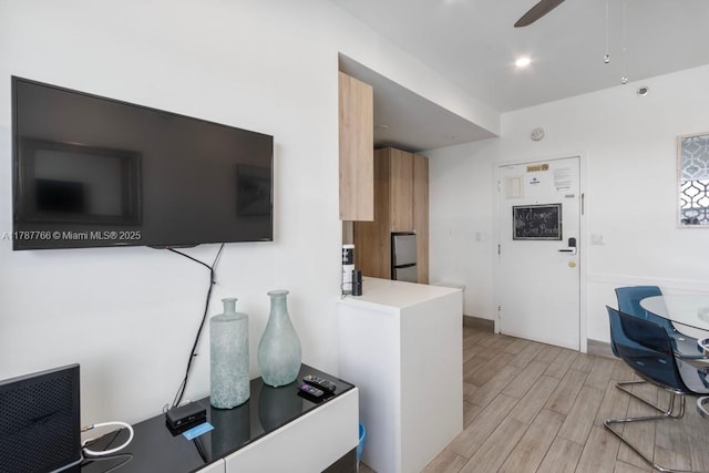 335 Ocean Dr Unit 122, Miami Beach, FL 33139 - kitchen with light countertops, light wood-type flooring, and a ceiling fan