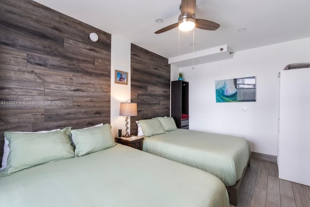 335 Ocean Dr Unit 122, Miami Beach, FL 33139 - bedroom with baseboards, a ceiling fan, wood finished floors, and wooden walls