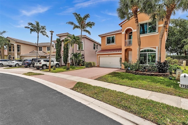 7738 NW 17th Pl, Pembroke Pines, FL 33024 - view of front of home with a garage, a tiled roof, stucco siding, and driveway