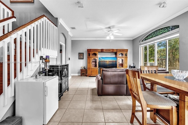 7738 NW 17th Pl, Pembroke Pines, FL 33024 - living room with a ceiling fan, ornamental molding, stairs, light tile patterned floors, and baseboards