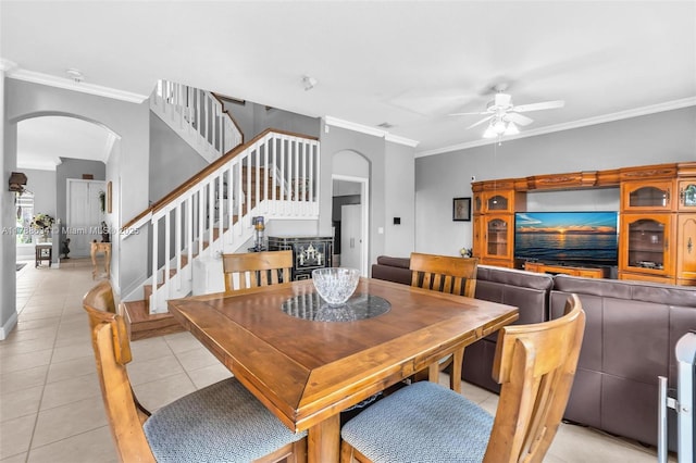 7738 NW 17th Pl, Pembroke Pines, FL 33024 - dining area with arched walkways, a ceiling fan, light tile patterned floors, ornamental molding, and stairway