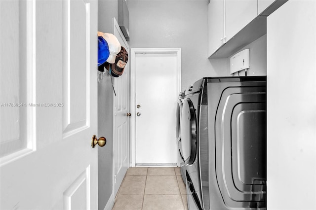 7738 NW 17th Pl, Pembroke Pines, FL 33024 - washroom featuring separate washer and dryer, cabinet space, and light tile patterned flooring