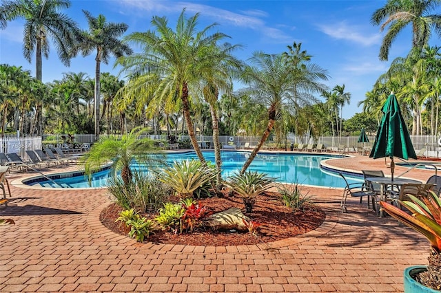 7738 NW 17th Pl, Pembroke Pines, FL 33024 - community pool with a patio area and view of wooded area