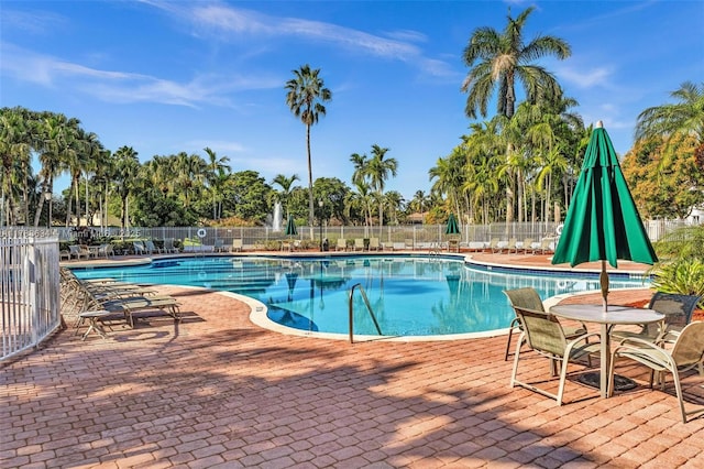 7738 NW 17th Pl, Pembroke Pines, FL 33024 - community pool featuring a patio and view of wooded area
