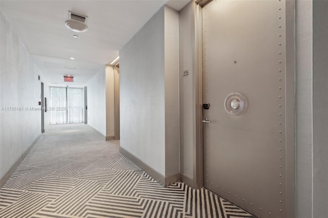 hall with carpet and baseboards