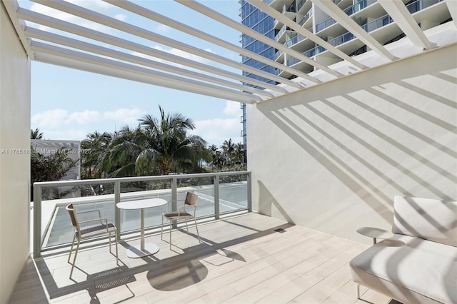 balcony featuring a pergola