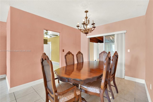 dining room featuring ceiling fan with notable chandelier, baseboards, and light tile patterned floors