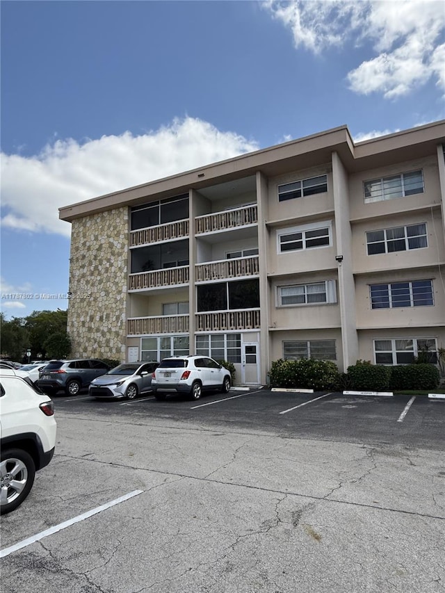 view of property with uncovered parking